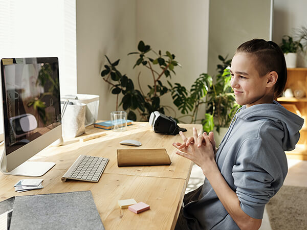 A photograph of a young boy on a desktop computer  - Chaos Theory | Serious Games Developer, Australia